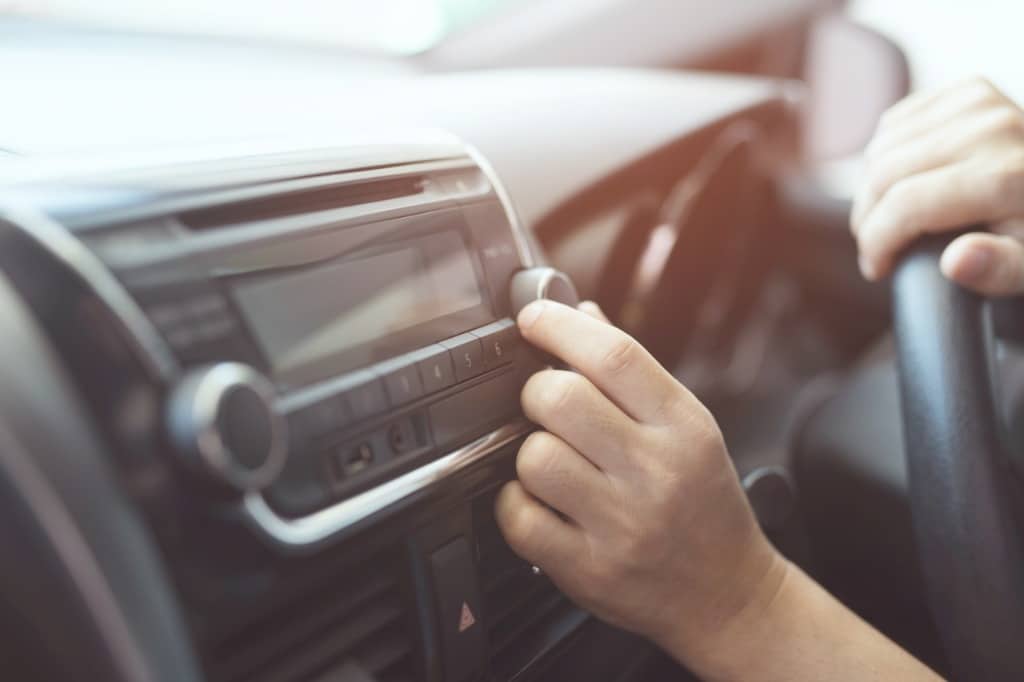 person-tuning-car-radio
